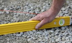 a man is measuring the ground with a tape