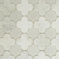 a white marble tile with an intricate design