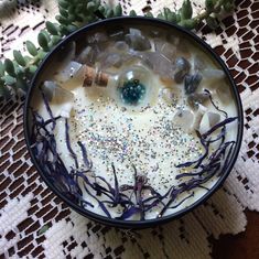 a bowl filled with lots of ice and sprinkles on top of a table