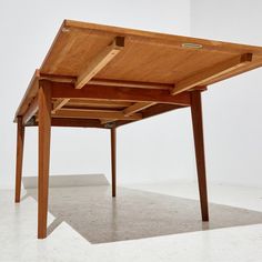 a wooden table sitting on top of a white floor