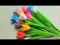 a bunch of colorful paper flowers sitting on top of a table