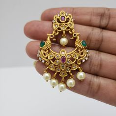 This beautiful earrings set has an excellent finish and gives out an exquisite sense of style. If you are looking for an amazing Fashion Jewelry set for special occasions such as Anniversary, Engagement, Party, Wedding, or for gifting, then your search ends here. Handmade Indian Temple Jewelry, best to wear it for traditional ceremonies or Indian wedding. This bridal jewelry has an ethnic finish. It has Cubic Zircon stones with semi-precious ruby and emeralds. It is a Bollywood style one gram je Elegant Chandbalis With Peacock Design For Diwali, Kundan Bridal Earrings In Temple Jewelry Style, Kundan Temple Jewelry Bridal Earrings, Kundan Bridal Earrings With Elegant Temple Design, Bollywood Style Gold Plated Pearl Earrings For Wedding, Elegant Chandbalis With Peacock Design For Celebration, Elegant Gold Plated Bridal Necklace With Latkans, Traditional Yellow Gold Pearl Earrings For Wedding, Elegant Bridal Necklace With Latkans In Gold Plated