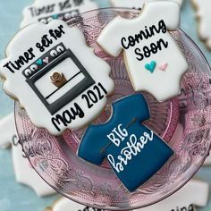 decorated cookies are sitting on a plate in the shape of t - shirt and sweaters