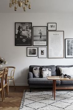 a living room filled with furniture and pictures on the wall