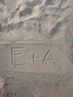 the letters e and f are drawn in the sand