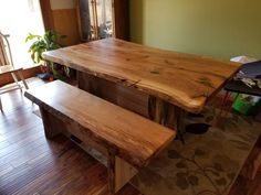 a wooden table and bench in a room