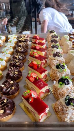 an assortment of pastries on display in a bakery