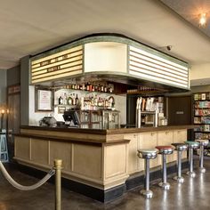 a bar with several stools in front of it