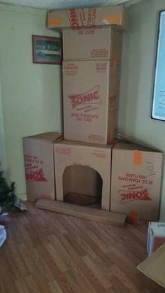 three cardboard boxes stacked on top of each other in the middle of a living room