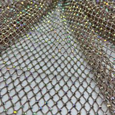 Diamond Fishnet is a high quality fabric ideal for high fashion concepts, swim cover ups, couture, and dancewear. The rhinestones are adhered with a strong grade adhesive to secure the stones in place. The fabric is designed to provide a luxurious, shimmering texture ideal for beachwear and other special occasions. The adhesive bonds the rhinestones to the fabric, allowing them to remain in place through washing and wear. This fabric is lightweight and strong, withstanding the test of time. The