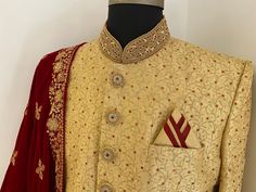 This is a Beige embroidered made to measure sherwani set that comes with red velvet shawl. The red stones on this sherwani looks elegant.it has mandarin collar, long sleeves,knee length, straight hem . This sherwani is all that you need to make an amazing first impression at a wedding or any event. Colour options available. Customisation available. Includes- sherwani and bottom For any queries or customisation plz WhatsApp me on +918291343471. Mens Ethnic Wear, Velvet Shawl, Men's Ethnic Wear, Red Stones, Nehru Jacket, Nehru Jackets, Red Stone, Mens Costumes, Ethnic Wear