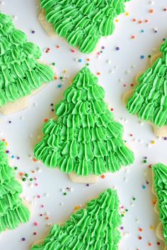 green frosted christmas tree cookies on a white platter