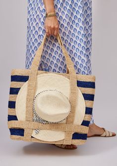 Our favorite Original Straw Traveler Bag now in two stripe colorways is sure to brighten up your spring and summer with a special built in spot for you favorite sunhat! Packable for easy travel and roomie for all of your sarongs, bathing suits and sunscreen. Shop Toast Stripe and Natural *hat sold separately Material: Striped Travel Bags For Summer, Striped Beach Bag For Everyday Summer Use, Striped Woven Travel Bag, Woven Striped Travel Bag, Striped Bags For Spring Beach Outings, Striped Travel Bags With Adjustable Strap, Rectangular Vacation Bag With Striped Lining, Rectangular Vacation Bags With Striped Lining, Spring Striped Beach Bags