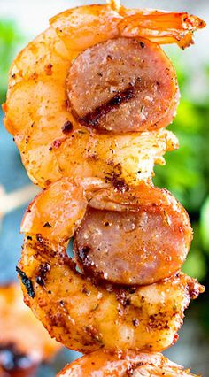 shrimp and sausage skewers are stacked on top of each other