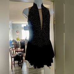 a dress is hanging on a mannequin in a room