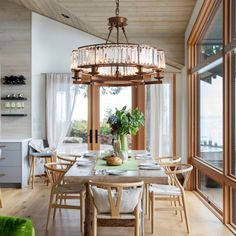 a chandelier hanging from the ceiling in a dining room