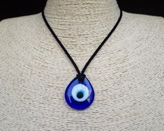 "Evil Eye Necklace Cord Pendant Turkish Evil Eye Glass Pendant Cord Necklace Blue Evl Eye Choker Amulet Necklace Christmas Gift We use only real photos,what you see is what you get. Jewelry colors may vary slightly due to monitor calibration Made with the utmost care to enjoy it as long as possible. All jewelries are are in stock and ready to be shipped within 1-2 business day from ordering to dispatch. Please note these times increase during Christmas & busy periods. 🌍 SHIPPING & DELIVERY This Blue Eye Necklace, Funky Necklace, Turkish Eye, Pretty Pens, Turkish Evil Eye, Necklace Cord, Amulet Necklace, Eye Glass, Necklace Blue