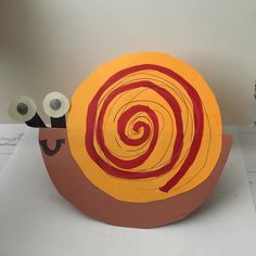 a paper plate that has two rolls of toilet paper on it and one roll is in the shape of a snail