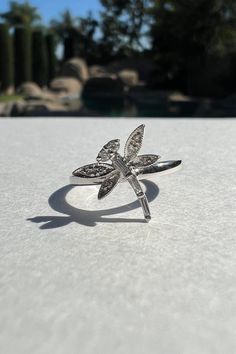 "A timeless and classic design, symbolizing strength and everlasting love. Perfect for everyday wear or dressed up for special occasions. Make a bold statement in our Genuine Diamond Dragonfly Ring, handcrafted in 14k white gold.  Item Specifications: Materials: 14k White Gold  Gemstone: Natural Diamond Dragonfly Diameter: 11.6mm x 11.6mm Total Gold Weight: 1.69 ct. Total Diamond Carat Weight: 0.10 ct. Diamond Clarity: SI 1-2 Diamond Color: G-H color ★  Each order will be beautifully packaged in a jewelry box and comes with a drawstring pouch that's perfect for travel. LiebeJewelry's products are handcrafted and all materials are genuine and ethically sourced. If you have any additional questions about this ring, just hit the \"Ask a Question\" button (just to the right of the price) and w Elegant Adjustable Butterfly Ring, Elegant White Gold Butterfly Promise Ring, Elegant Sterling Silver Butterfly Promise Ring, Elegant Sterling Silver Butterfly Ring For Anniversary, Classic Silver Butterfly Ring For Anniversary, Elegant Silver Butterfly Ring With Vvs Clarity, Luxury Silver Round Butterfly Ring, Formal Silver Butterfly Ring With Brilliant Cut, Silver Butterfly Ring With Brilliant Cut For Anniversary