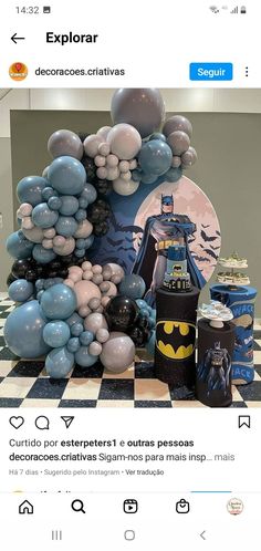 the batman balloon arch is on display in front of a checkerboard floor and wall