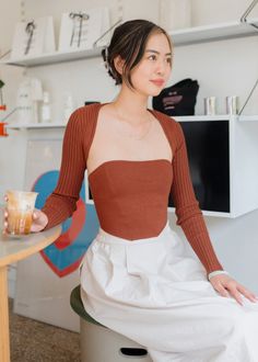 Our Simple Bolero Set - Cinnamon is a sweater corset tube top and shrug bolero cardigan set. It features a thick, smooth knit corset top with visible stitching and an adjustable lace up tie at back. The matching knit bolero long sleeve top is ribbed and has a snug fit. Model wears a size small Model is 5'1" 50% Viscose, 30% Nylon, 20% Polyester Size small measurements: Bust: 22" Waist: 20" Sweater Corset, Knit Corset Top, Bolero Long Sleeve, Knit Corset, Girls Corset, Knit Bolero, Bolero Cardigan, Cardigan Set, Puff Jacket