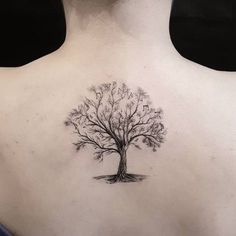 a woman with a tree tattoo on her back