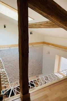 an empty room with wooden beams and white walls, in the process of being renovated