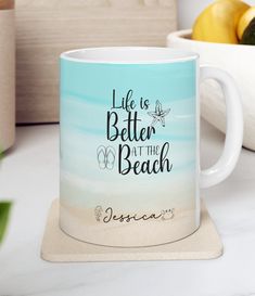 a blue and white coffee mug with the words life is better at the beach on it