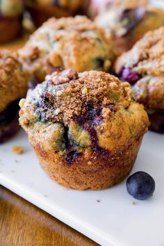 several blueberry muffins on a cutting board