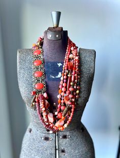 As we head into fall, I am still focused on incorporating as much color as possible into my style of work. How fun in this stunning yet bright piece?!  This piece has all the wonderful colors of fall from muted tones of red orange to dark topaz!  I have found that my creative mind is loving to work with the same colors for a few pieces and then change it up as I go to another.  On the top left side is a stunning vintage Sarah Coventry repurposed coral lucite piece repurposed into this big beaded Necklace Long Gold, Colors Of Fall, Gold Long Necklace, Handmade African, Necklace Red, Coral Necklace, Sarah Coventry, Muted Tones, Creative Mind