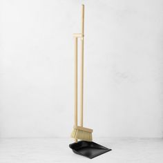 a broom and dustpan sitting on top of a white floor