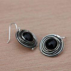 I hand crafted these earrings out of sterling silver and bezel set a black onyx in the center, adding some oxidizer for depth and character, and a shiny buffed finish. Each pair of earrings is totally handmade and unique! Now available in 1/2", 5/8" and 3/4" circle size---french wires are sterling silver,too! Perfect for casual and business wear accessory~looks great with almost anything! **Matching necklaces are available Material: Silver (.925). All materials are hypoallergenic. These Earrings Unique Round Earrings With Polished Finish, Nickel-free Silver Onyx Earrings, Black Sterling Silver Jewelry With Oxidized Finish, Black Oxidized Sterling Silver Jewelry, Black Drop Earrings With Oxidized Finish, Silver Onyx Earrings Perfect As A Gift, Handmade Black Round Earrings, Onyx Round Earrings For Gift, Polished Onyx Earrings For Gift