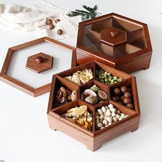 an assortment of nuts in wooden containers on a table