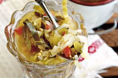 a glass bowl filled with food and a spoon