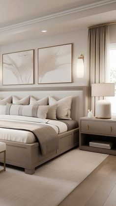 a large white bed sitting in a bedroom next to two lamps on either side of the bed