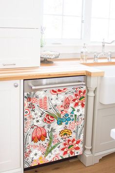 a dishwasher sitting on top of a kitchen counter next to a sink and window