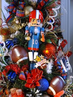 a christmas tree decorated with football ornaments