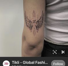 a person with a tattoo on their arm and the words tiki global fashion below it