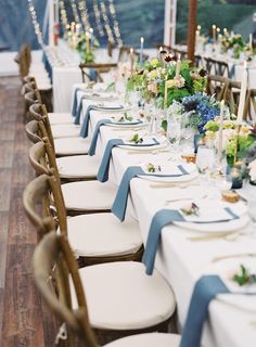 the wedding table is set with white and blue linens