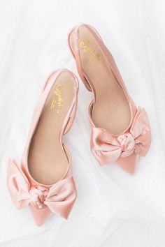 An understated heel with a slingback means you won’t be slipping these off when it comes time to dance. Plus that satin bow? Perfect. | Photo: @stephh.walker Feminine Low Heel Slingback Pumps For Wedding, Spring Evening Slingback Wedding Shoes, Spring Evening Wedding Slingback Shoes, Feminine Slingback Pumps With Bow Straps For Party, Feminine Party Slingback Pumps With Bow Straps, Spring Evening Wedding Shoes With Satin Bow, Chic Slingback Wedding Shoes For Spring, Spring Wedding Shoes In Satin With Pointed Toe, Chic Bow Slingback Pumps For Wedding