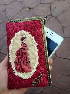 a hand holding a cell phone case with an image of a woman in a red dress