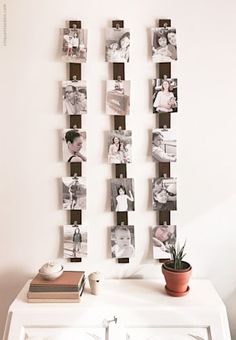 a white table topped with pictures and a potted plant