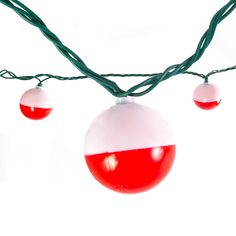 some red and white balls are hanging from a wire with green wires on it, against a white background