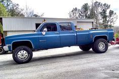 a blue truck parked in front of a building