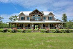 a large house sitting on top of a lush green field