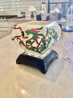 a vase sitting on top of a counter in a kitchen