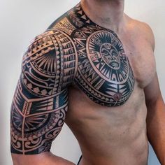 a man with a tattoo on his arm and chest