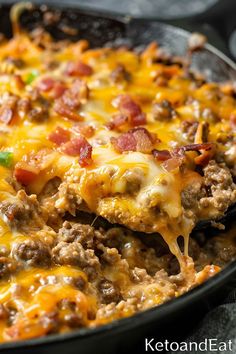 a skillet filled with meat and cheese