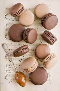 some macaroons are sitting on top of sheet music