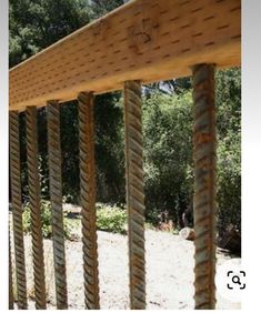 an image of a wooden structure with ropes on it's sides and trees in the background